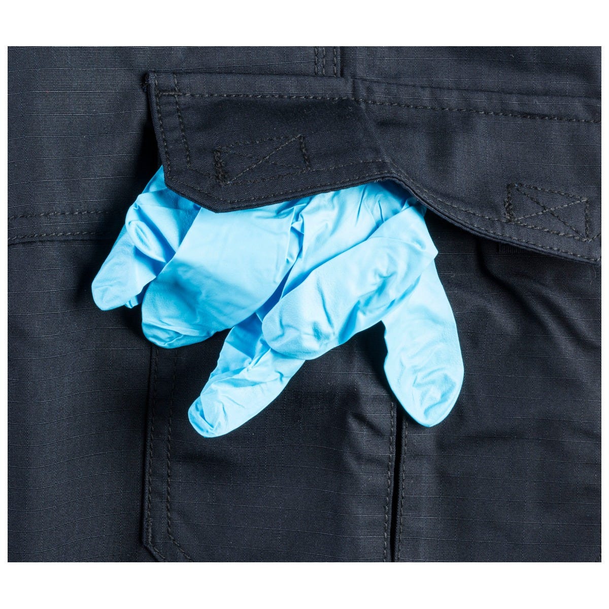 Blue gloves being put into a black pocket